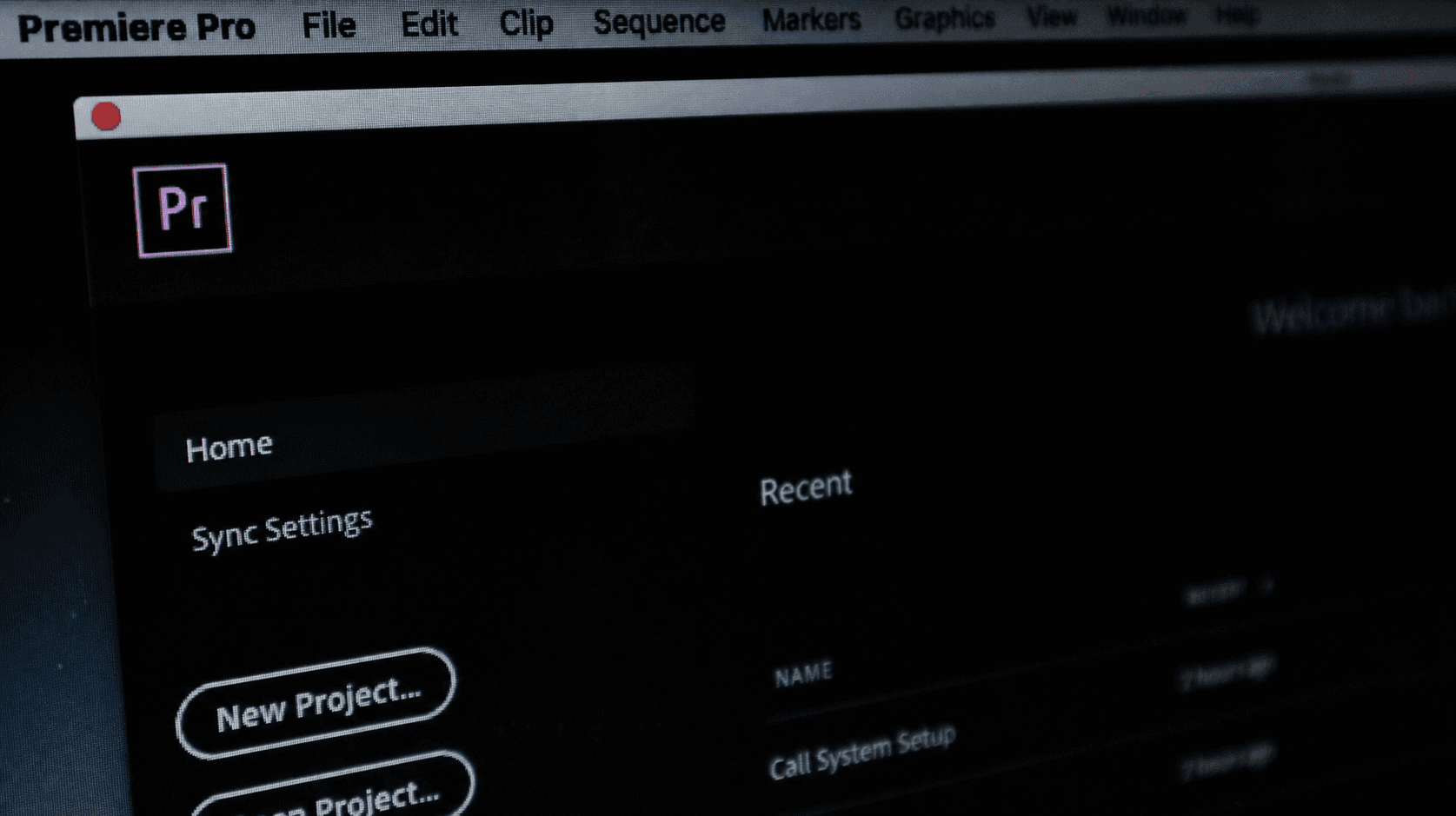 Adobe Premiere Pro home screen interface on a computer monitor showing the new project button.